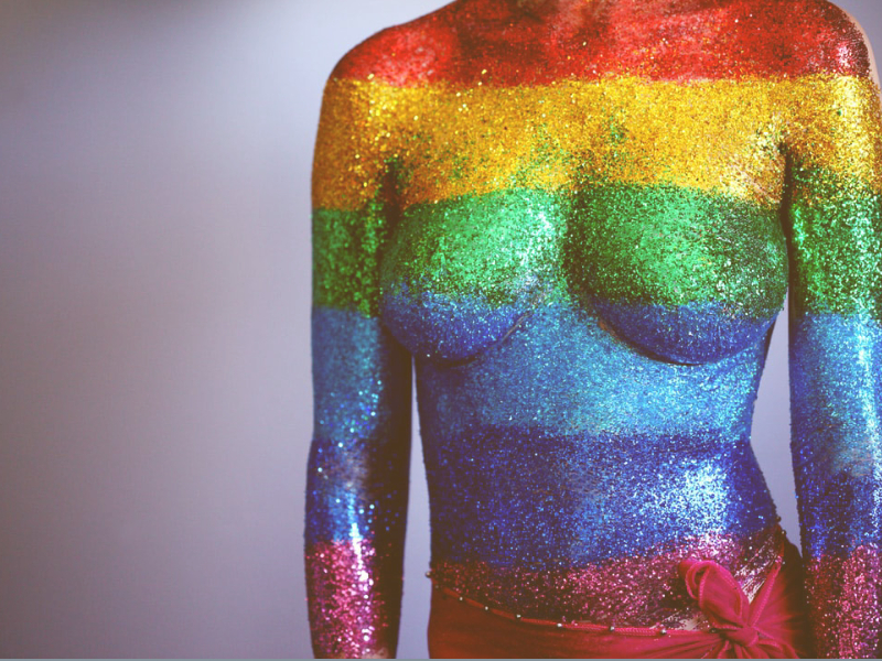 Illustration of a female figure in multi color body paint to display concepts of unique anatomy and individuality